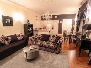 - un salon avec un canapé et une table dans l'établissement Sneaton Hall Apartment 4, à Whitby