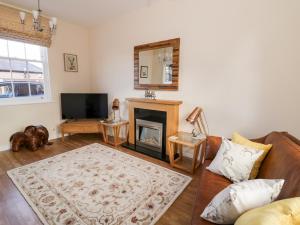 a living room with a couch and a fireplace at 7 Mart Lane in Stourport