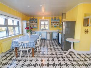 a kitchen with a table and chairs and a refrigerator at Longfield Lodge in Killarney