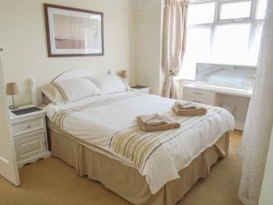 a bedroom with a bed with two towels on it at 32 Cranleigh Close in Bournemouth