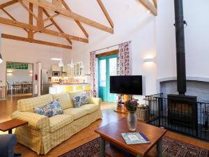a living room with a couch and a fireplace at The Granary in Tavistock
