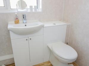 une salle de bain blanche avec un lavabo et des toilettes dans l'établissement 5 Ceirnioge Cottages, à Betws-y-coed 7 autres photos