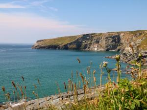 a view of a body of water with a cliff at Rock House in Tintagel