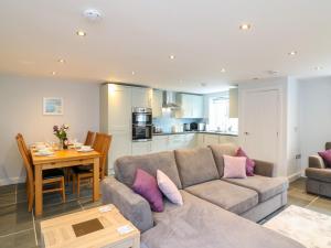 a living room with a couch and a table at Exmoor View in South Molton