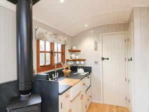 a kitchen with a stove and a sink at Little Silver Leaf in High Bickington