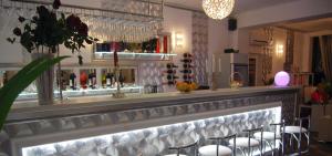 a bar with chairs and a counter with wine glasses at Casa OK by OVO in Vama Veche
