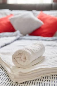 a stack of towels sitting on top of a bed at Modern Apartment suitable for Longstays in Vienna