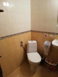 a bathroom with a toilet and a sink at Hristovi Apartments & Studios in Pomorie