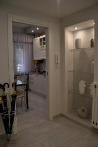 a kitchen with white cabinets and a table and chairs at GIGLIARELLI AD MAISON in Perugia
