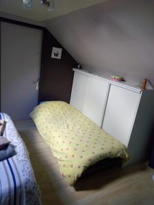 a bedroom with a bed and a pillow on the floor at les vignes d'Ygrande in Ygrande