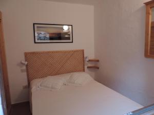 Säng eller sängar i ett rum på Inter-Résidences Costa Smeralda