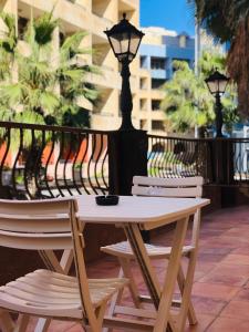 a table and chairs on a patio with a street light at Napoli Suites in St. Julianʼs