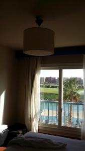 A bed or beds in a room at Amazing view apartment in Golf Porto Marina with marina access