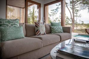 a couch with pillows on it in a living room at Pestana Troia Eco-Resort & Residences in Troia