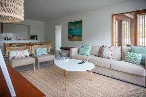 a living room with a couch and a table at Pestana Troia Eco-Resort & Residences in Troia