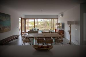 a living room with a wooden table and chairs at Pestana Troia Eco-Resort & Residences in Troia