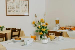 ヴィニャカストリジにあるIL MELOGRANO B&Bの花瓶とオレンジジュースを添えたテーブル