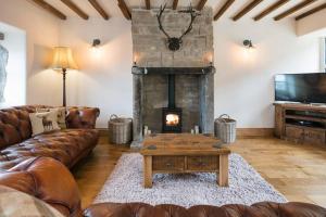 a living room with a couch and a fireplace at Stunning Blackberry Cottage with Log Burner - located on Haworth Main Street in Haworth