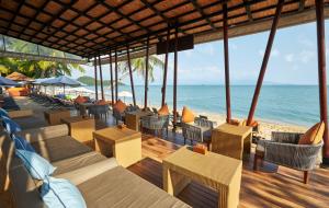 a restaurant on the beach with tables and chairs at Bandara Spa Resort & Pool Villas, Samui in Bophut