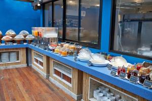 a buffet line with plates and bowls of food at Bandara Spa Resort & Pool Villas, Samui in Bophut