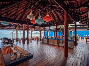 a restaurant on the beach with a bar and lights at Bandara Spa Resort & Pool Villas, Samui in Bophut
