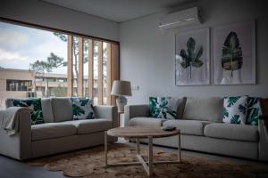 a living room with a couch and a coffee table at Pestana Troia Eco-Resort & Residences in Troia