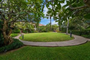 a walkway through a park with grass and trees at Bandara Spa Resort & Pool Villas, Samui in Bophut
