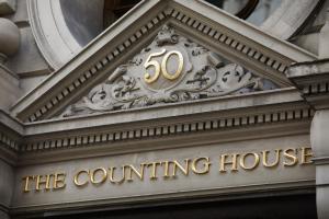 
a building with a large clock on the front of it at Counting House in London
