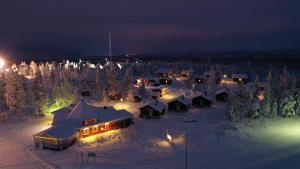 an aerial view of a snow covered village at night at Aava Sky Village Aurinkomaja in Aavasaksa