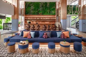 a living room with a blue couch and someools at Bandara Spa Resort & Pool Villas, Samui in Bophut
