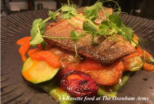 a plate of food with meat and vegetables on it at The Oxenham Arms Hotel Devon in South Zeal