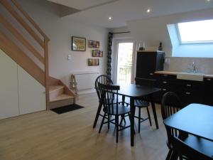 a kitchen and dining room with a table and chairs at Les Bordes in Vineuil