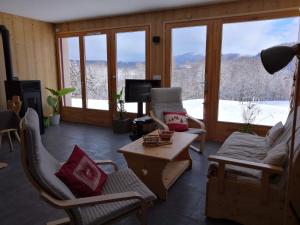 a living room with a view of a mountain at gite haut Jura in Chaux-des-Crotenay
