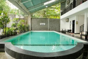 an indoor swimming pool with blue water in a building at SUPER OYO 409 Pondok Helomi in Yogyakarta