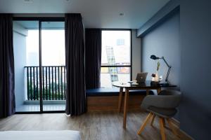 Ein Bett oder Betten in einem Zimmer der Unterkunft The Quarter Ladprao by UHG