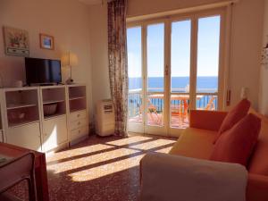 a living room with a view of the ocean at Le Casasse "Paradiso" in Varigotti