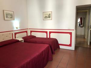 a hotel room with two beds and a hallway at Startermini in Rome