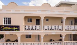 a building with a sign on the side of it at Calliandras Apartment Complex in Kingstown