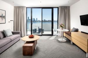a living room with a couch and a table at Quest South Perth Foreshore in Perth