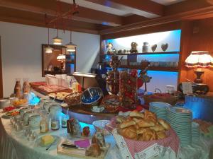 a table topped with plates and bowls of food at Sportpension Christina by PiaundDirk in Fügen