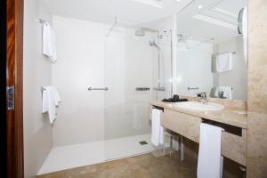 a bathroom with a sink, toilet and shower at Hotel Bahía in Santander