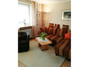 a living room with a couch and a table at Ferienwohnung Christian in Bad Birnbach