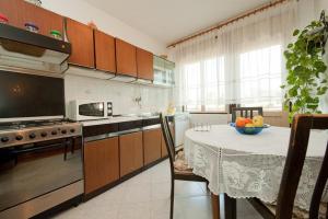 a kitchen with a table with a bowl of fruit on it at Apartment Patricia in Rovinj