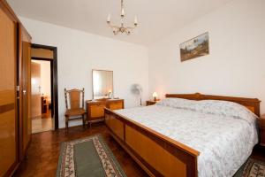 a bedroom with a large bed and a chandelier at Apartment Patricia in Rovinj