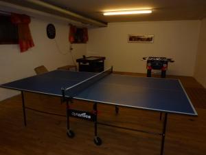 a ping pong table in the middle of a room at Gästehaus Christa in Obermaiselstein +18 photos