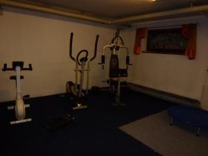 a gym with cardio equipment in a room at Gästehaus Christa in Obermaiselstein