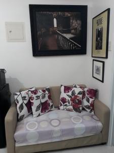 a couch with pillows on it in a living room at HappyNest Couple room DF in Tagaytay +11 photos