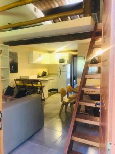 a kitchen and dining room with a staircase in a house at Duplex Ilhabela Pereque in Ilhabela