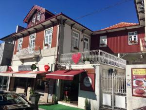 a building with a red heart on the side of it at Casas Rosa Sousa in Felgueiras