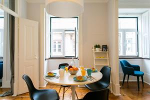 a small dining room with a table and chairs at JOIVY Splendid 2BR flat in Bairro Alto, nearby Luís de Camões Square in Lisbon